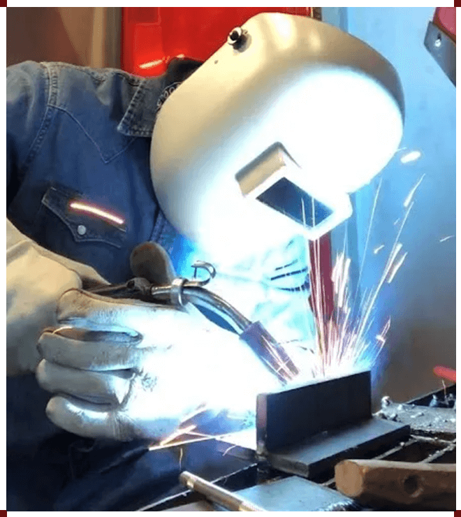 A person welding with a mask on.