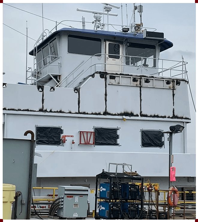 A large white boat with a blue top.