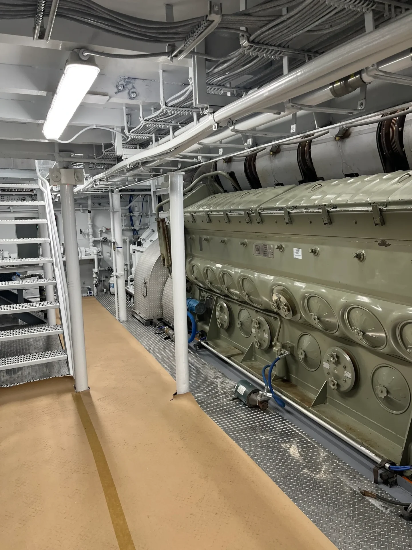 A large machine room with many pipes and equipment.