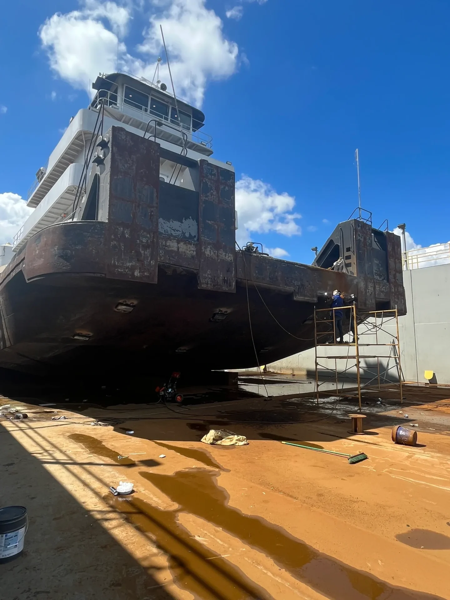 A large boat is being lifted by crane.