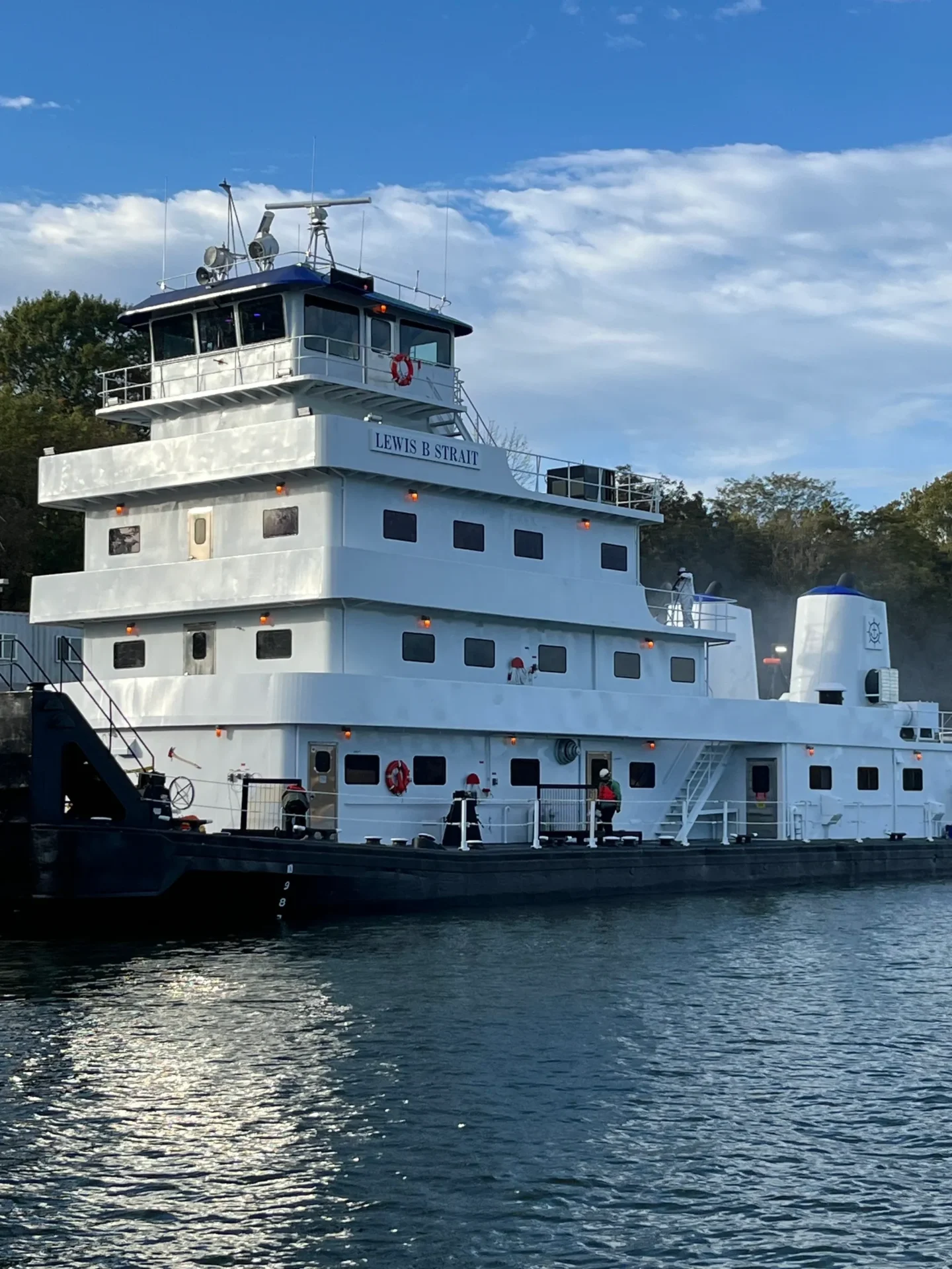 A large white boat floating on top of water.